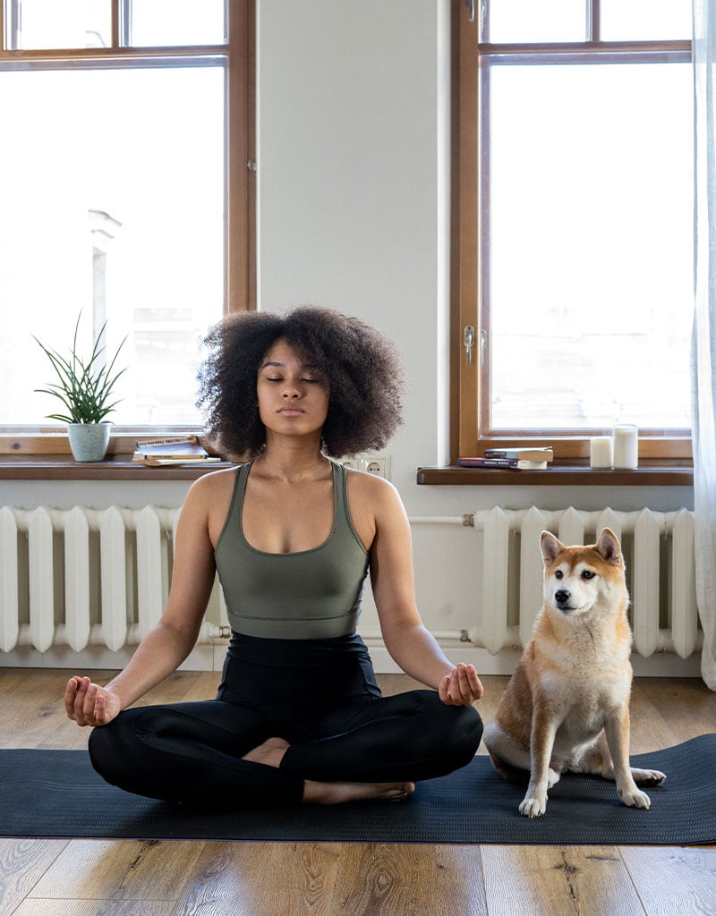 woman with dog meditating